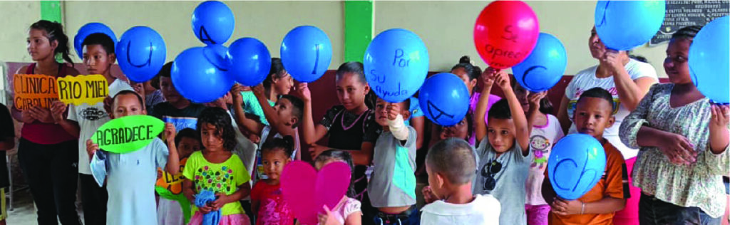 A group of children holding balloons