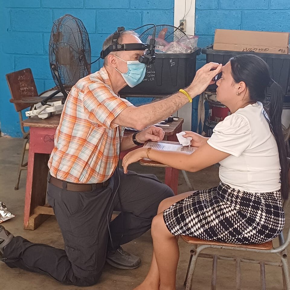 Healthcare worker examining patient's eye